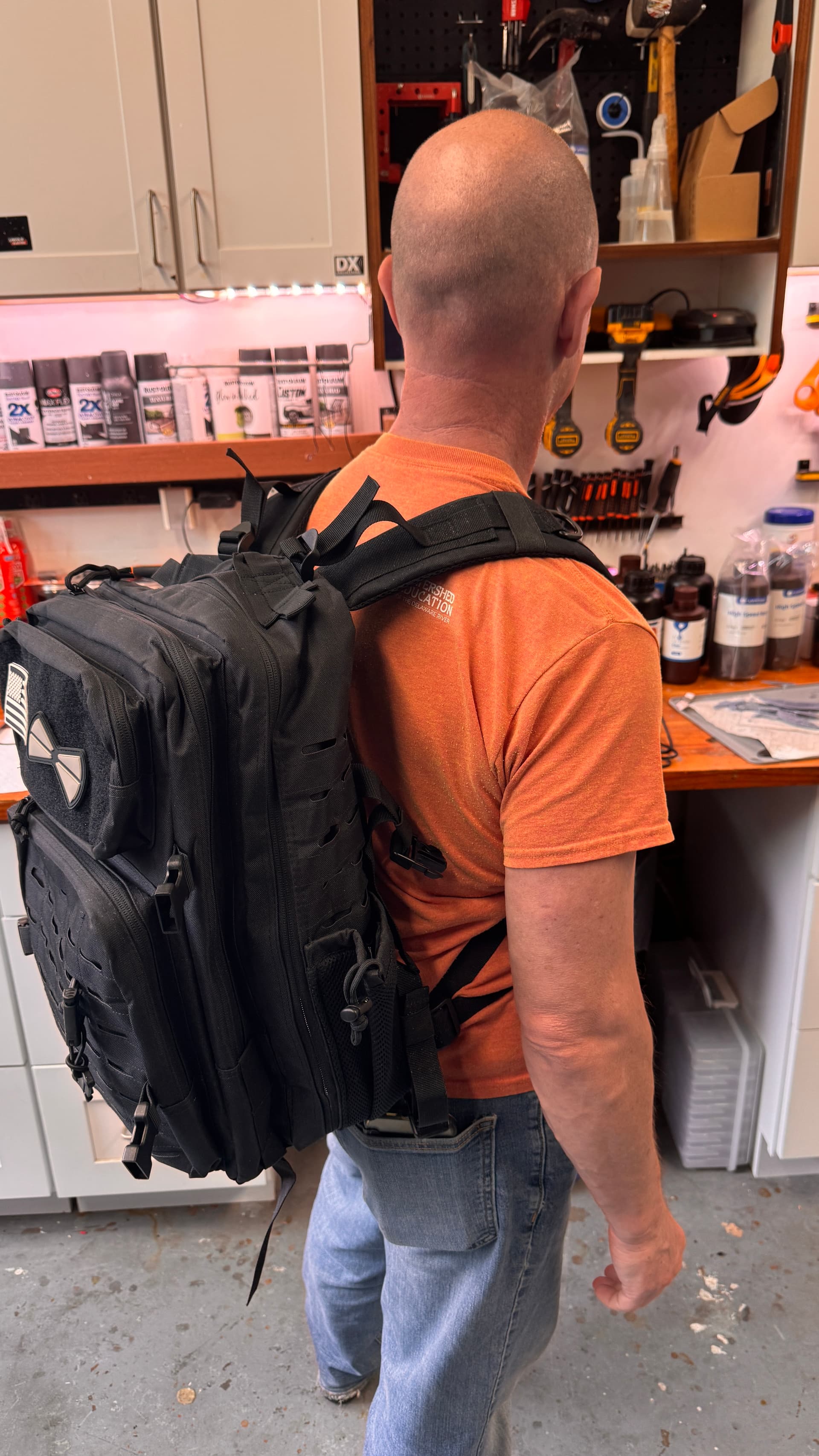 Person carrying the complete emergency radio kit in a backpack during field testing
