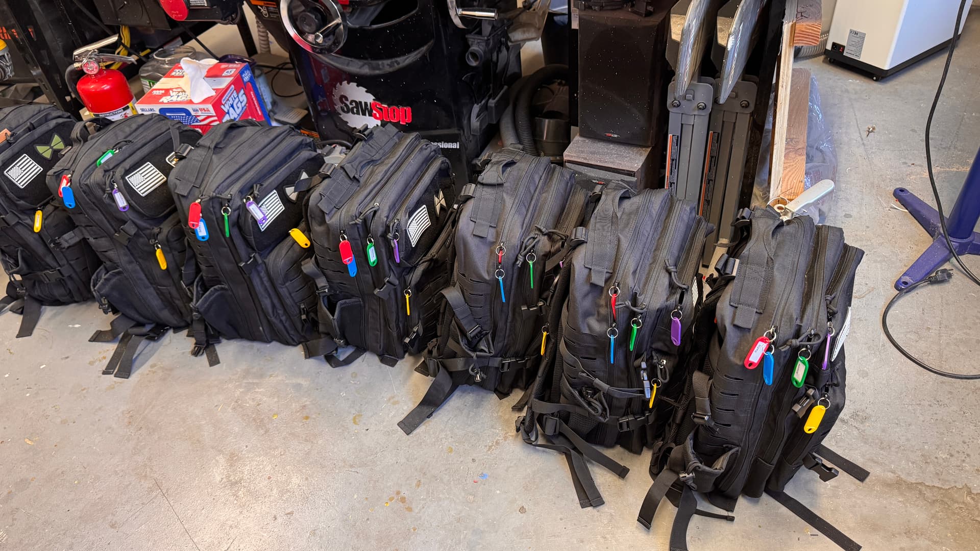 Seven complete emergency radio base station kits laid out with all components